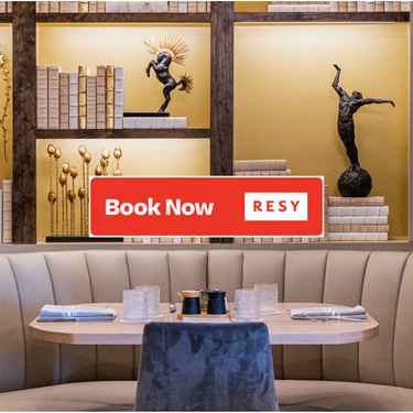 Photo of booth seating in the restaurant and 'Book Now Resy' overlay on top of the image.