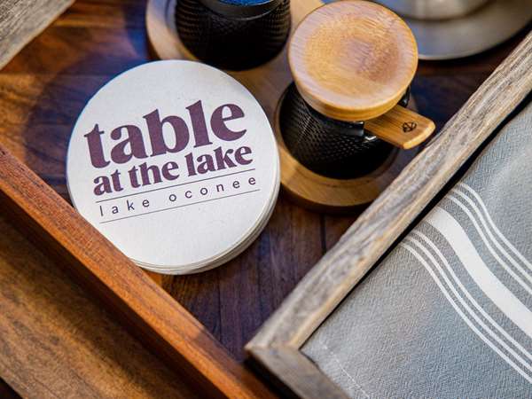 Branded coaster with a salt and pepper mill on a tray